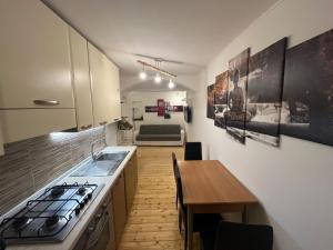 a kitchen with a sink and a wooden table at La casa di Iole in Maratea