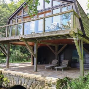 a large wooden deck with chairs on a house at Boat House Middleton Hall Estate in Belford