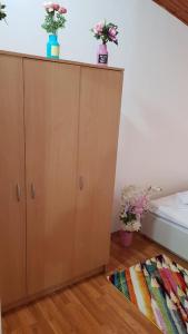 a cabinet with flowers on top of it in a room at Igalo Vuke in Igalo