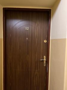 a wooden door with the number on it at ApartmentsByMatyrafa-IX in Tarnowskie Góry