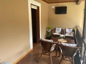 a balcony with a table and chairs and a television at Casa Mariyina in Ribadesella