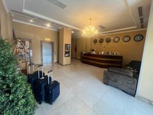 a lobby with two suitcases in front of a waiting room at Smith Hotel in Baku