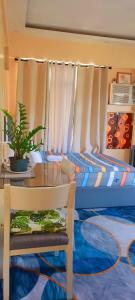 a bedroom with a bed with a table and a chair at Cozy Corner Haven near Venice Grand Canal Mall in Manila +19 photos