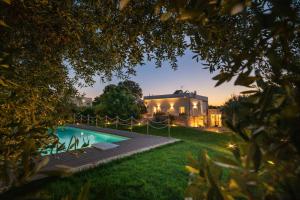 a house with a swimming pool in the yard at Ohana Alberobello in Alberobello