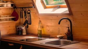 a kitchen counter with a sink and a window at Glamping Dragonja River in Šmarje