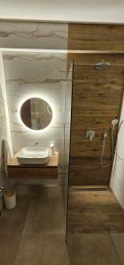 a bathroom with a sink and a mirror at Oliane Rooms & Accommodation in Bribir
