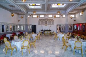 a dining room with tables and chairs and a ceiling at Amor Hotel in Fez