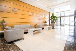 a lobby with couches and tables in a building at Aparthotel Albufera in Alfafar