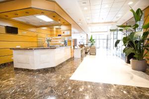 a lobby with a counter and plants in a building at Aparthotel Albufera in Alfafar +32 photos