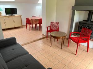 a living room with a couch and chairs and a table at LA POMMERAIE in Bosc-Bénard-Commin +2 photos