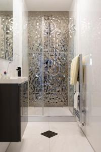a bathroom with a shower with a glass door at Munich Penthouse Rooftop Terrace in Munich
