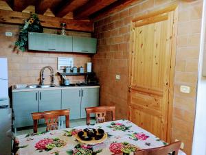 a kitchen with a table and chairs and a kitchen with a sink at Agriturismo PALMERI in Avola