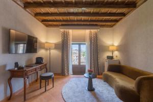 a living room with a couch and a table at Donna Camilla Savelli - VRetreats in Rome