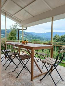 a wooden table and chairs on a patio at Casa Los Naranxales Gijon in Gijón
