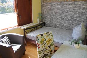 a small room with a bed and a chair at Ferienhaus am Belmermoor 167 in Brunsbüttel