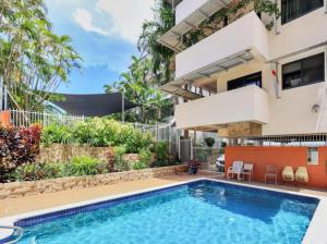 a swimming pool in front of a house at Holiday at Harry Chan Darwin CBD Location Plus in Darwin