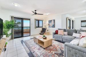 a living room with a couch and a table at Holiday at Harry Chan Darwin CBD Location Plus in Darwin