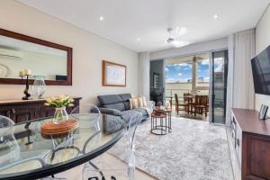 a living room with a glass table at Absolute Hidden Gem in CBD in Darwin