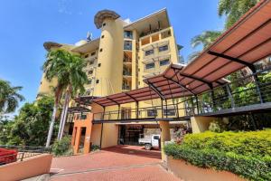 an exterior view of a building with palm trees at Darwin Esplanade Walk to Waterfront Wines and Waves in Darwin