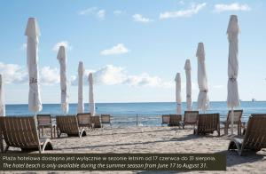 a group of umbrellas and chairs on a beach at Haffner Hotel & SPA Sopot - Destigo Hotels in Sopot +37 photos