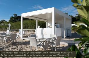 a white gazebo with a table and chairs at Hotel Haffner Resort & Spa - Destigo Hotels in Sopot +69 photos