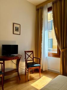 TV a/nebo společenská místnost v ubytování Locanda del Ghetto