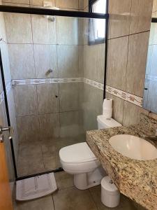 a bathroom with a toilet and a shower and a sink at Itupeva Plaza Hotel in Itupeva