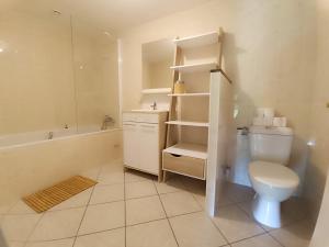 a white bathroom with a toilet and a sink at Gites de la Bénardière in Vallières-les-Grandes