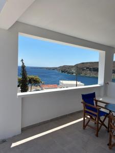 a balcony with a table and a view of the water at George Studios 1 in Kanala