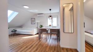 a living room with a table and a white couch at Greg's House Apartments in Ljubljana