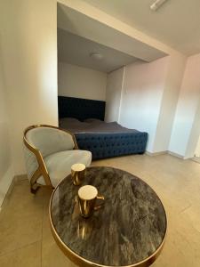 a living room with a table and a bed at Sebe apartments 4 in Holíč
