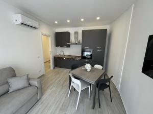 a living room with a table and a couch at L' Occhio del mare in Giardini Naxos