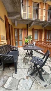 a patio with a table and chairs on a stone patio at Appartamento a Luino Cavallotti25 in Luino