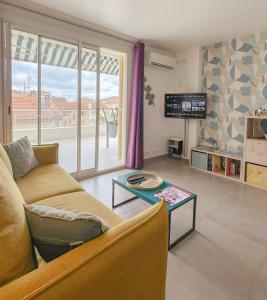 a living room with a couch and a table at Le Bobillot By ApiRent #Central #Terrasse #Wifi #Clim in Cannes +24 photos