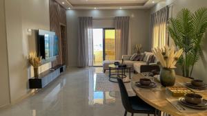 a living room with a table and a couch at Nozoll Boutique Residences in Amman