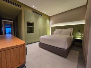 a bedroom with a large bed and a desk at The Address Resort , Marassi North Coast 2 bedrooms suite in Mājid Abū Zayd +66 photos