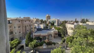 an aerial view of a city with buildings at Nozoll Boutique Residences in Amman