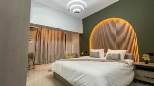 a bedroom with a large bed with a surfboard on the wall at Nozoll Boutique Residences in Amman