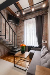 a living room with a brick wall at Royal mini apart-hotel on Kovzhyna in Lviv