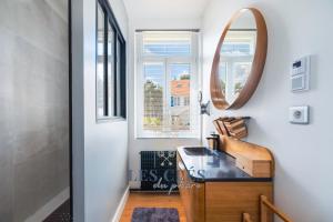 a bathroom with a sink and a mirror at La Bargnia : Maison Touquettoise in Le Touquet-Paris-Plage +32 photos