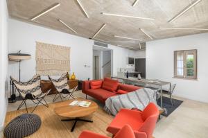 a living room with a red couch and chairs at Villa Calma in Šivati