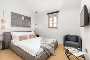 a bedroom with a bed and a chair at Villa Calma in Šivati +40 photos