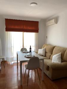 a living room with a couch and a table at Apartamento Salas in Ronda
