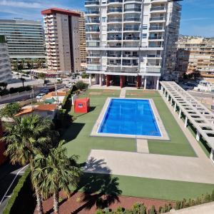 an overhead view of a building with a swimming pool at Horizonte beachfront apartment in Ifach