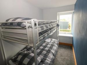 a bunk bed in a room with a window at The Old Post Office in Haverfordwest
