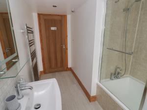 a bathroom with a sink and a shower and a tub at The Old Post Office in Haverfordwest +16 photos
