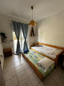 a bedroom with a large bed in a room at House 77 in Kallithea Halkidikis
