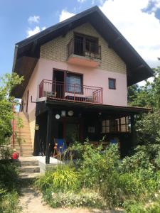 a house with a balcony on top of it at Kokin Brod Apartments in Kokin Brod