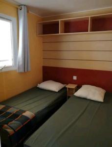 a bedroom with two beds and a window at 45mn de Paris Sympathique logement trois chambres - A76 in Saint-Chéron