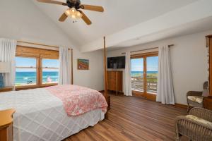 a bedroom with a bed and views of the ocean at NH340 Gillam Hall in Nags Head